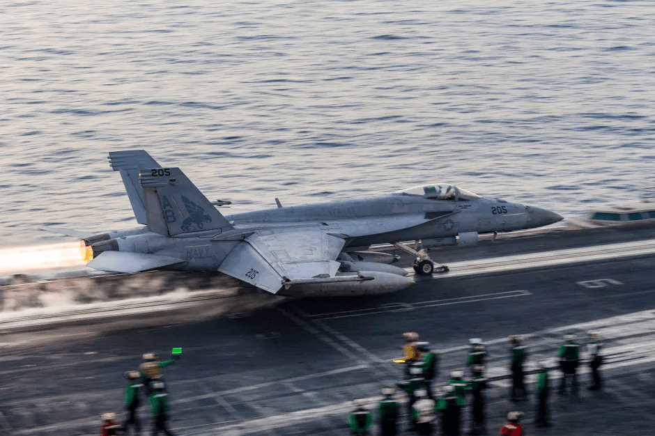 Navy F/A-18E Super Hornet launching from aircraft carrier.