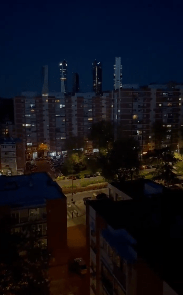 Night view of city buildings with skyscrapers in the background.
