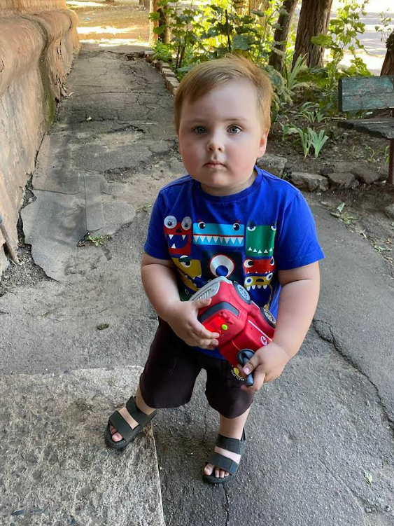 Toddler playing with a toy truck.