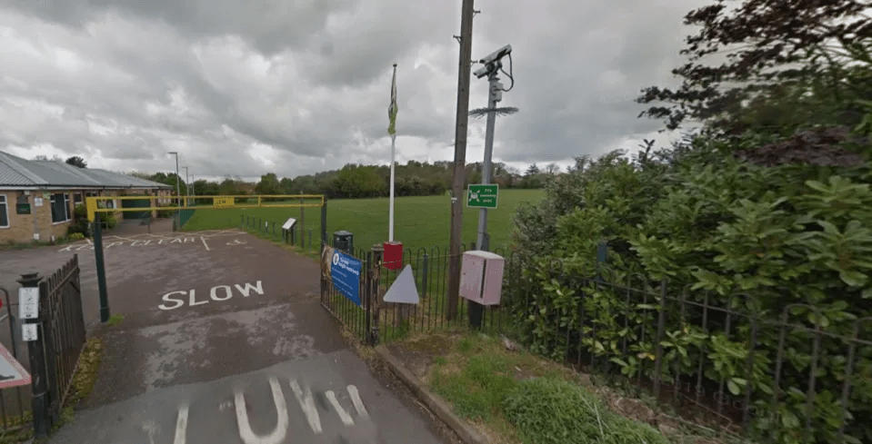 Entrance to a playing field with a security camera.