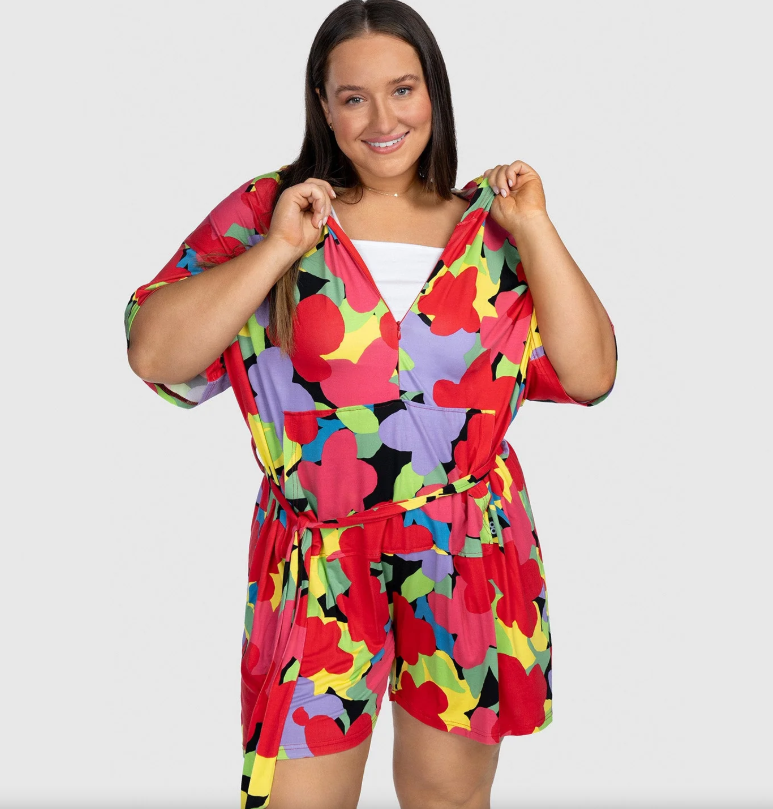 Woman in colorful floral jumpsuit.