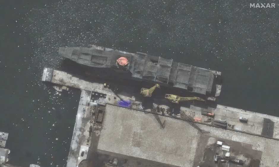 Aerial view of a large ship in dry dock.