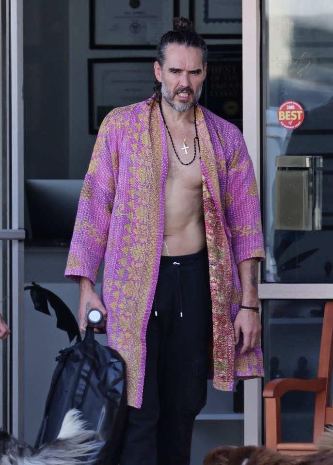 Man wearing a purple robe and black pants.
