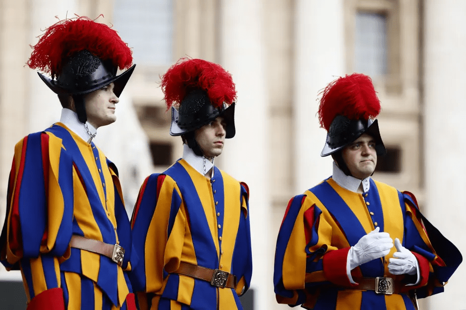 Three Swiss Guards in uniform.