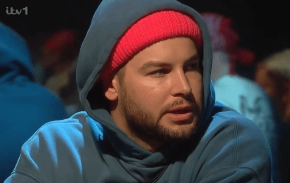 Man in a blue hoodie and pink beanie.