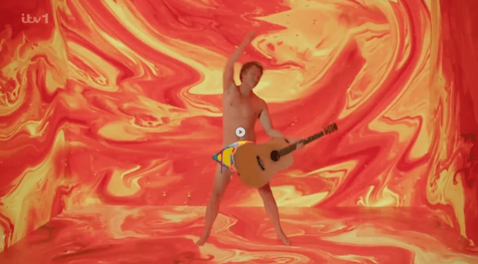 Man playing guitar in front of an orange and yellow background.