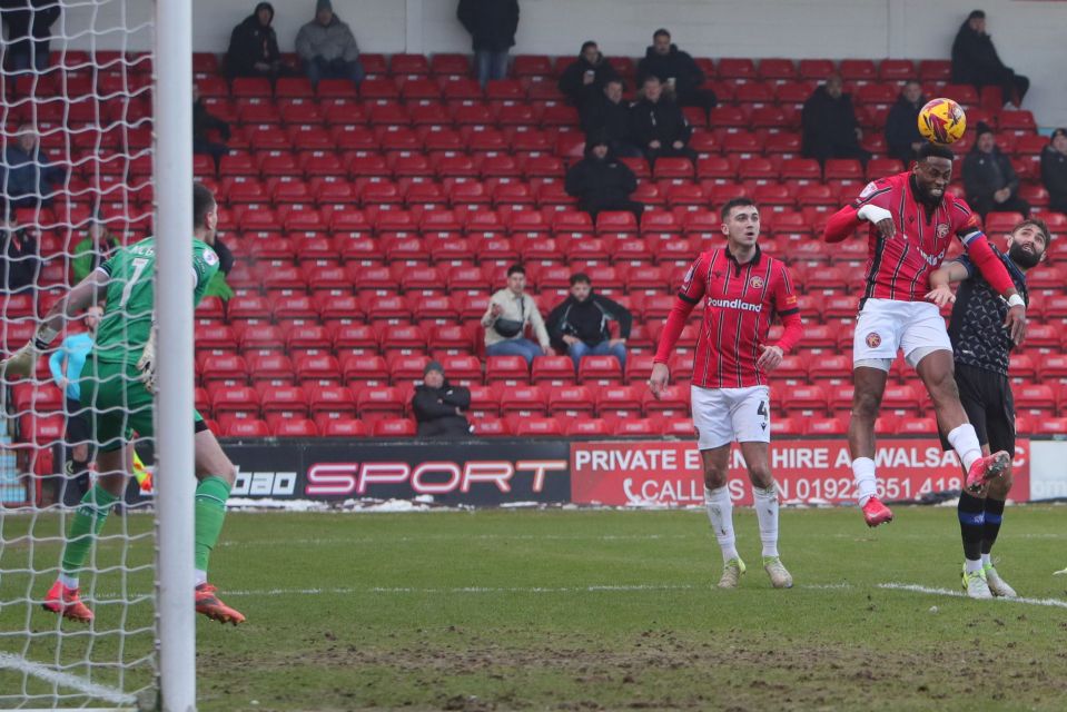 Jamille Matt of Walsall scoring a goal during a soccer match.