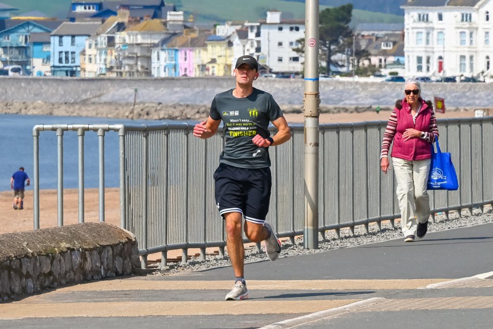 Jogger on a seafront promenade.