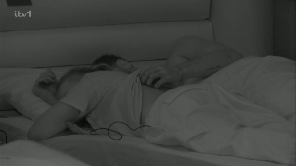 Jojo Siwa and Chris Hughes cuddling in bed.