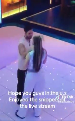 JoJo Siwa and Chris Hughes embracing.