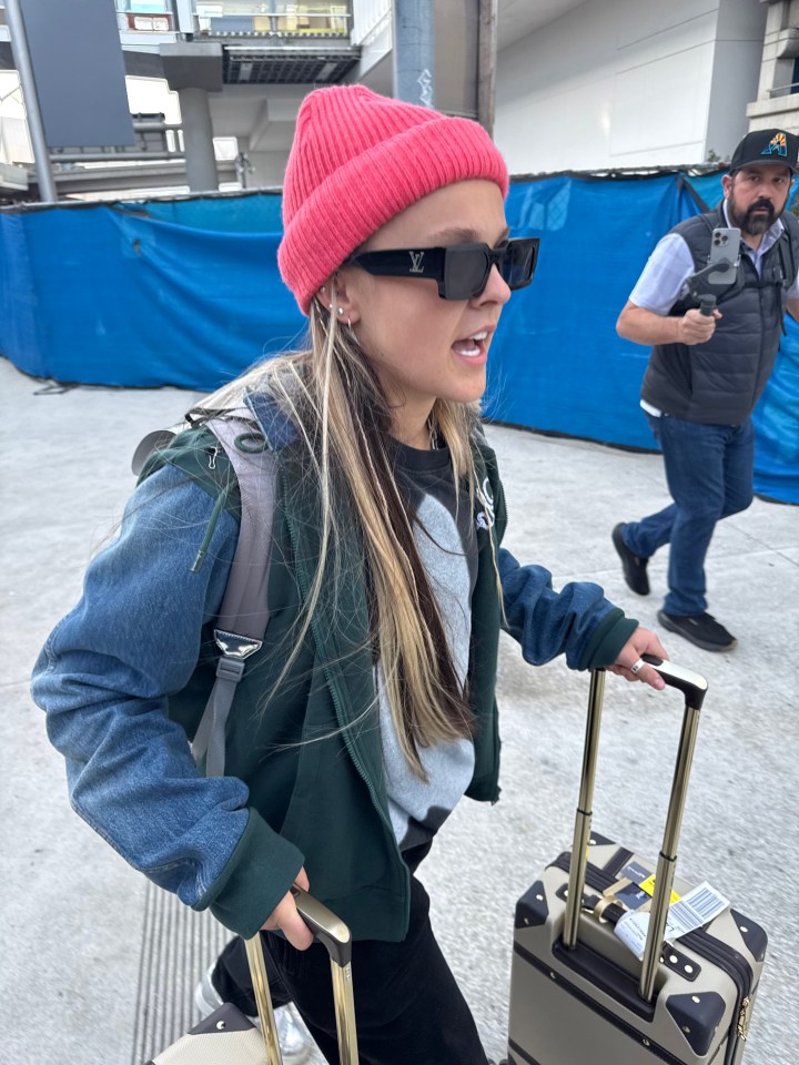 JoJo Siwa arriving at LAX with luggage.