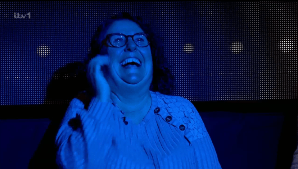 Woman laughing in blue light.