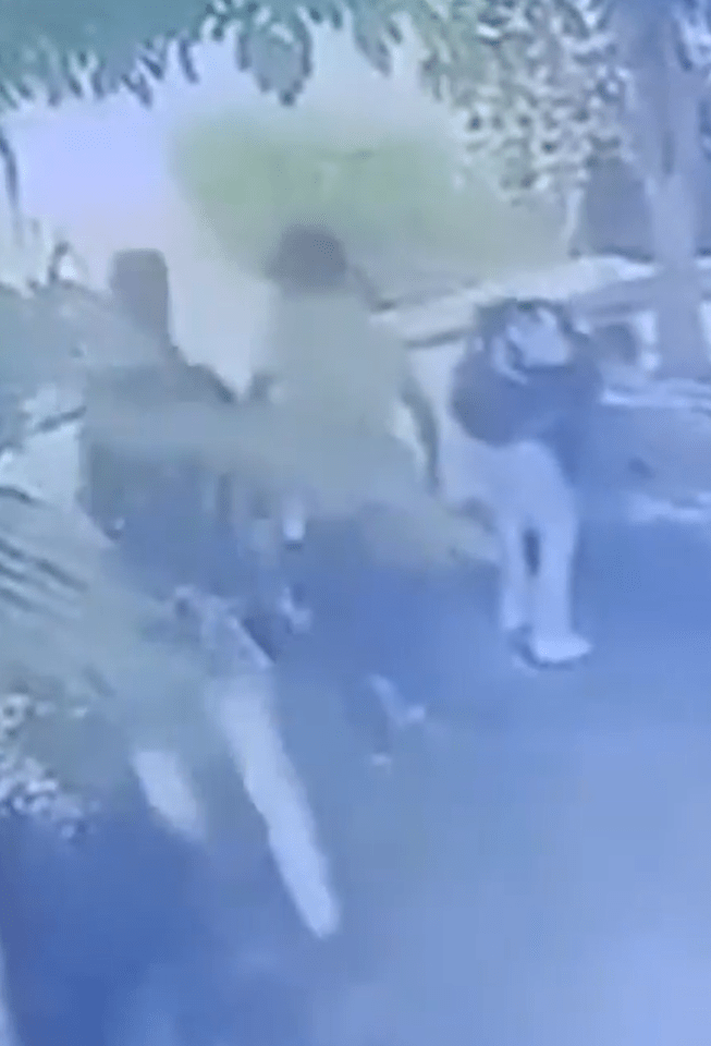 Security camera footage of people outdoors.