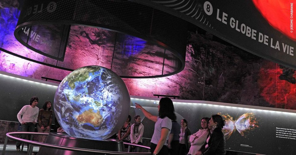 Large projected globe in a museum exhibit.