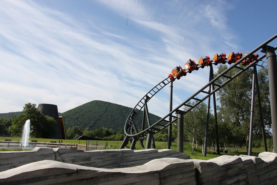Roller coaster cars rounding a curve at Vulcania.