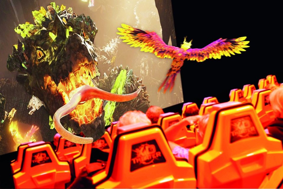 Vulcania ride showing a monster and bird on a large screen in front of moving seats.