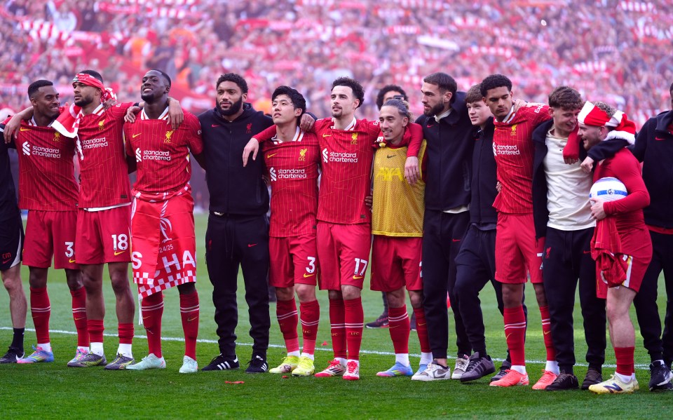 Liverpool players and staff celebrating a victory.