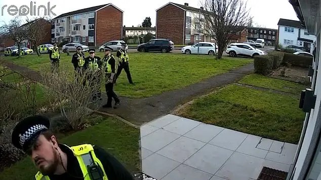 A man is arrested by several police officers.