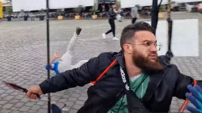 A man attacking people with a knife.