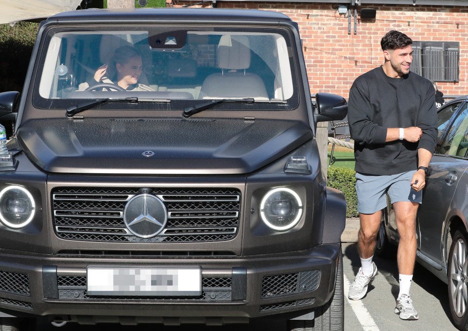 Molly Mae and Tommy Fury sitting in a Mercedes G-Wagon.