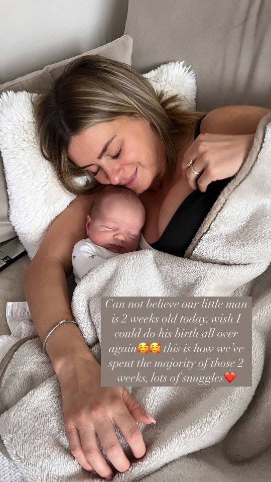 Mother cuddling her two-week-old baby.