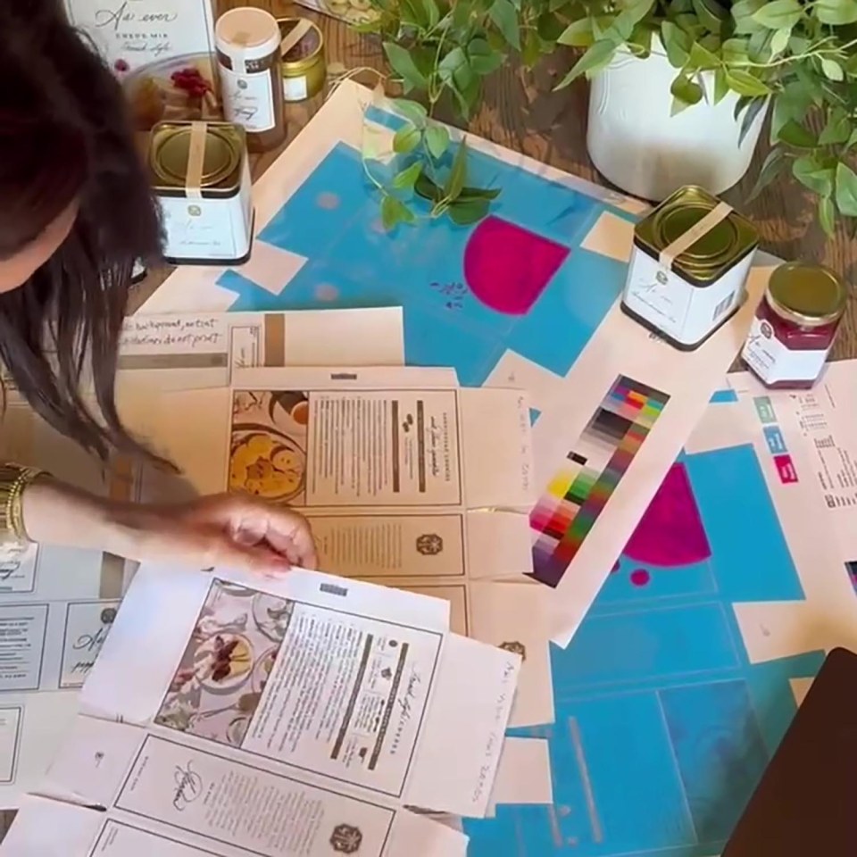 Woman reviewing packaging designs and samples.