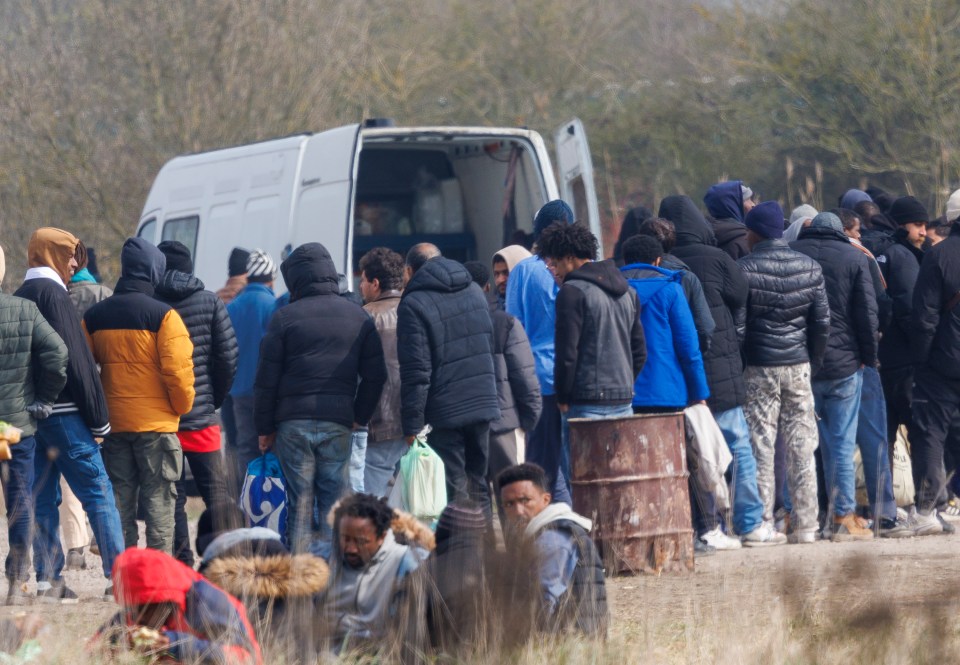 Migrants waiting in line for food near Grand-Synthe.