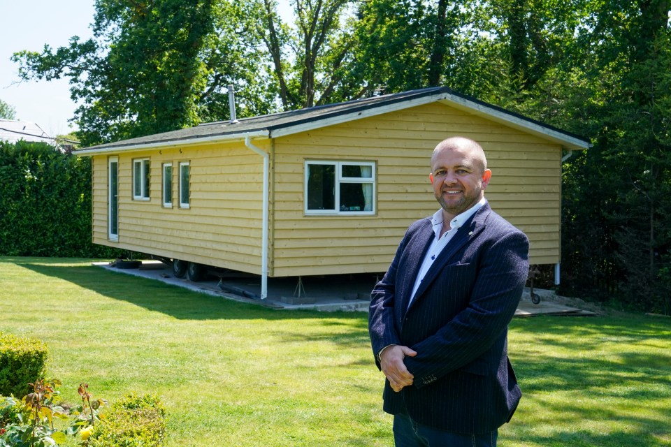 Millionaire Bob Bull standing in front of his home.