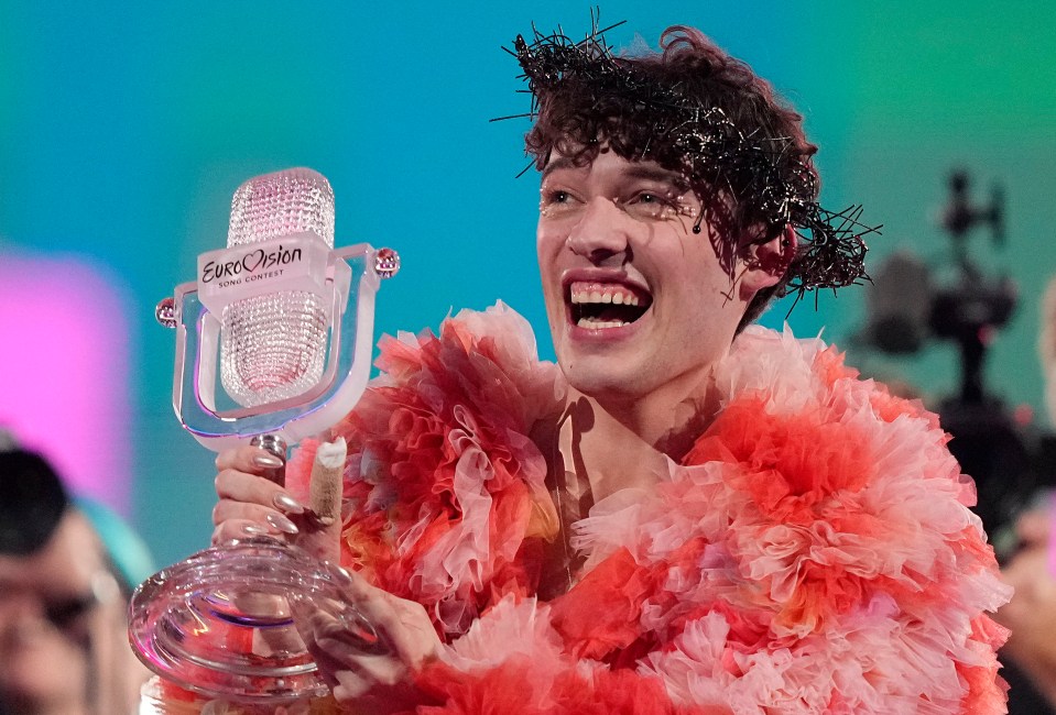 Nemo of Switzerland holding the Eurovision Song Contest trophy.