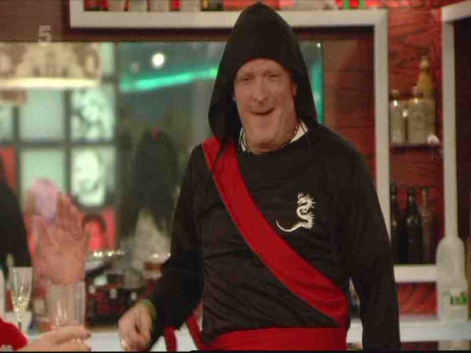 Michael Madsen in a black and red geisha costume on Big Brother.