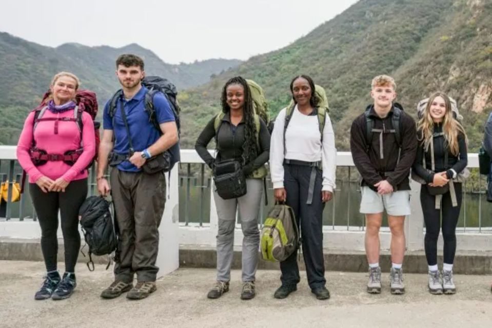 An image collage containing 1 images, Image 1 shows Ten contestants from Race Across the World posing for a photo at the Great Wall of China
