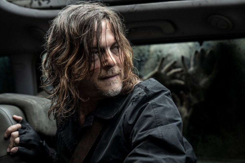 Norman Reedus as Daryl Dixon in a vehicle, with zombies visible outside.