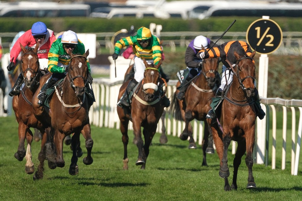 Horses racing at Aintree Racecourse.