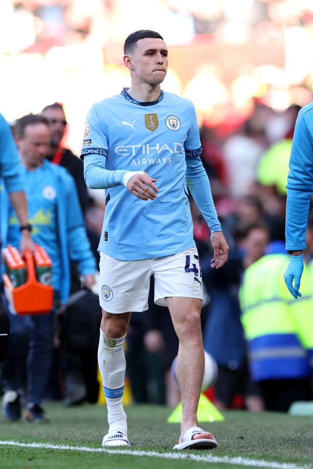Phil Foden of Manchester City leaves the pitch with an injury.