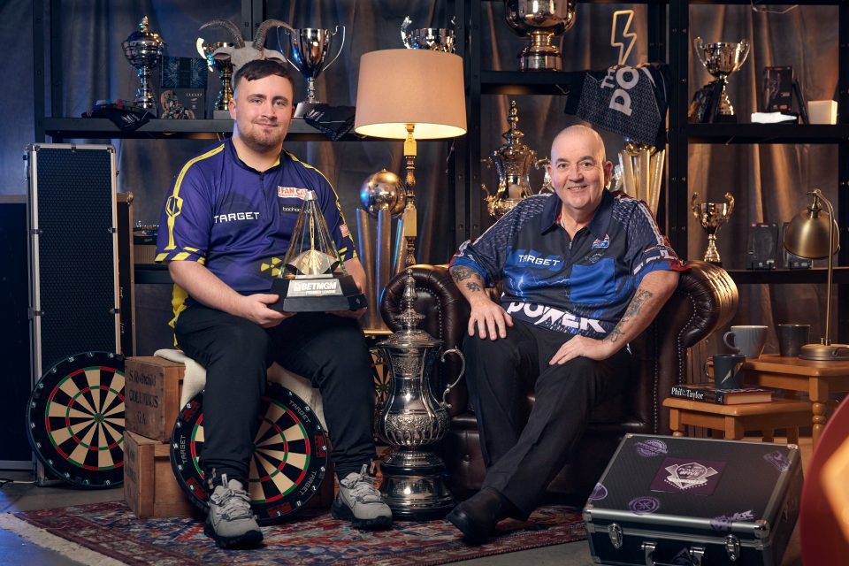 Phil Taylor and Luke Littler with trophies and dartboards.