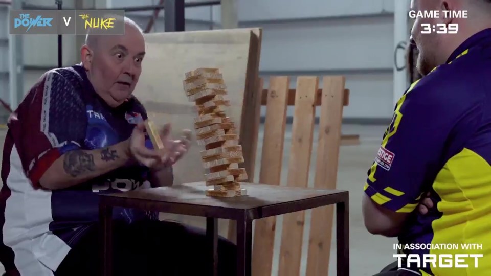 Phil Taylor and Luke Littler playing Jenga.