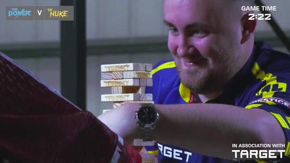 Phil Taylor and Luke Littler playing Jenga.