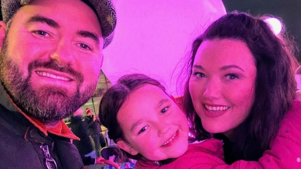 Photo of Ben and Lauren King with their daughter.
