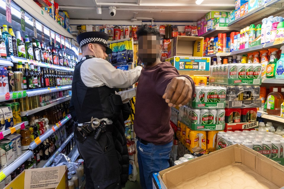 Police officer questioning a shop worker.