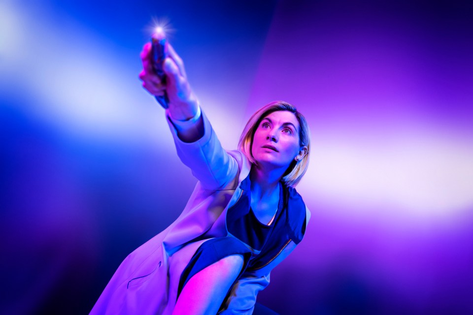 Jodie Whittaker as the Doctor, holding the sonic screwdriver.