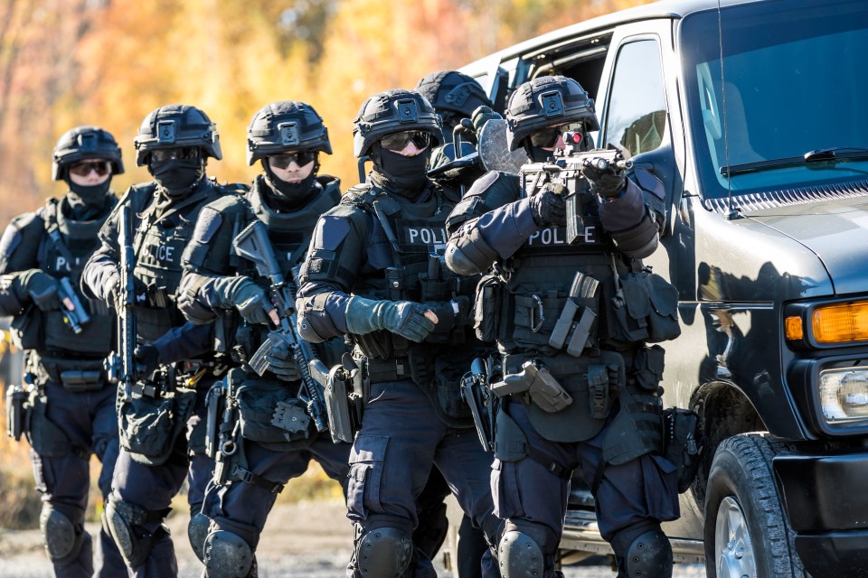SWAT team exiting a vehicle.