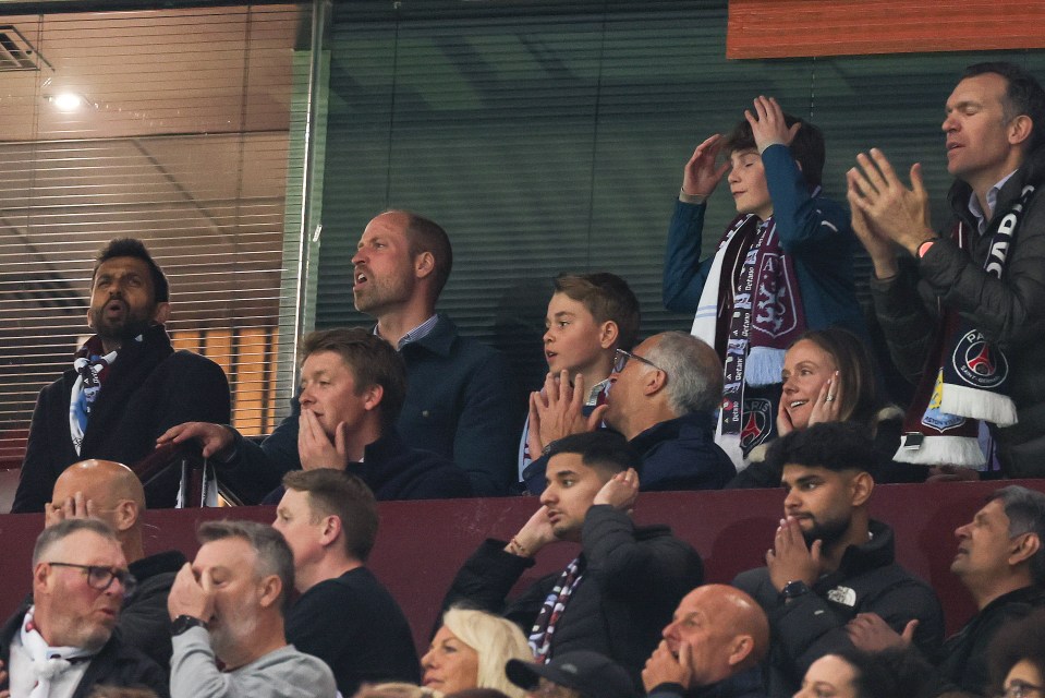 Prince William, Prince George, and other spectators watching a soccer match.