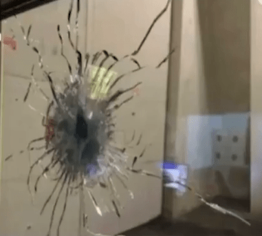 Bullet hole in a glass window.
