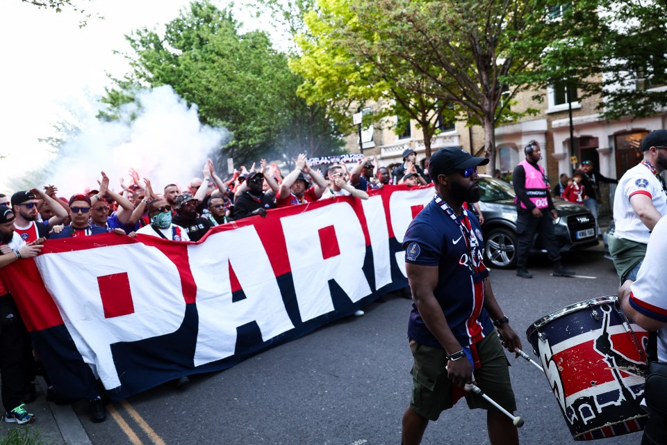 PSG supporters carrying a "Paris" banner.