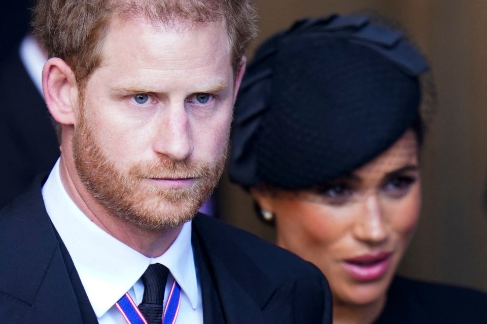 Prince Harry and Meghan Markle leaving a service for Queen Elizabeth II's coffin.