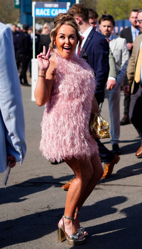 Racegoer in pink feather dress at the Randox Grand National Festival.