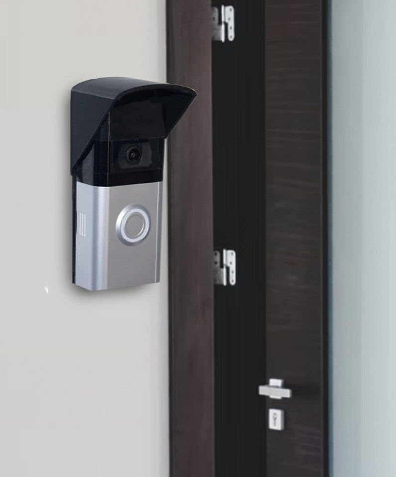 Video doorbell with rain cover mounted on a wall.