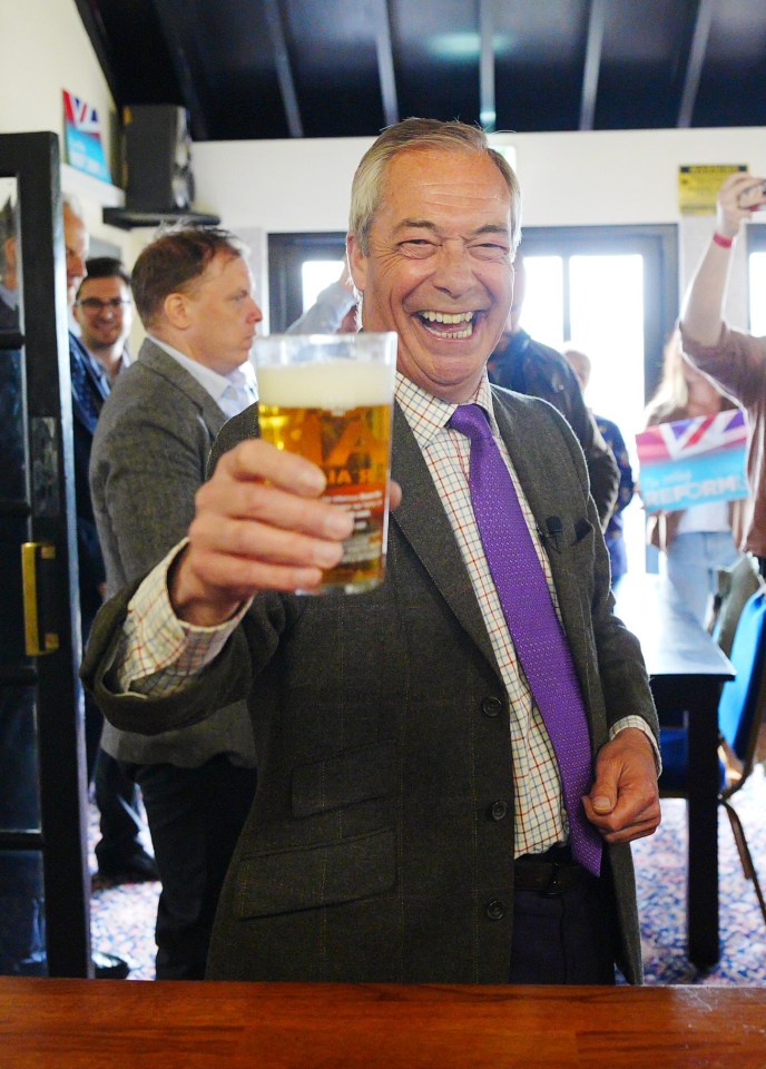 Nigel Farage raising a pint of beer during an election campaign.