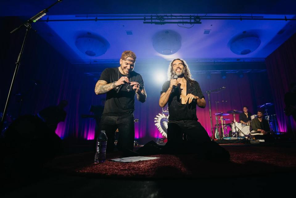 Russell Brand and Brandon Lake onstage at the Riviera Theater in South Carolina.