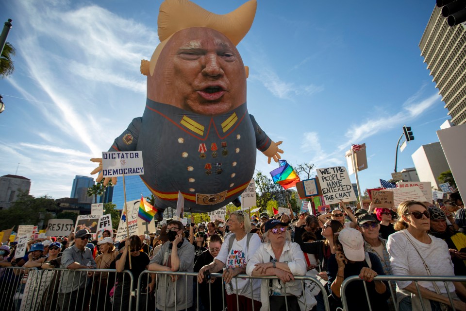 Protest against the Trump administration featuring a large inflatable depiction of Trump.